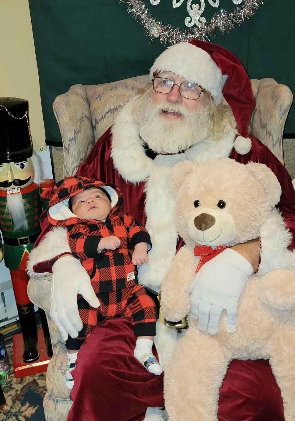 Santa holding a 5 week old baby 2023